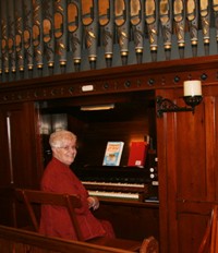 Betty Scroggy in familiar pose at the organ.
